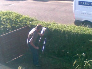 Cutting the Neighbours hedge with a Flymo Lawnmower